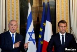 French President Emmanuel Macron and Israeli Prime Minister Benjamin Netanyahu attend a joint news conference at the Elysee Palace in Paris, Dec. 10, 2017.