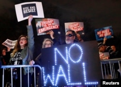FILE - People protest President Donald Trump's declaration of a national emergency to build a border wall, outside Trump International Hotel & Tower in Manhattan, N.Y., Feb. 15, 2019.