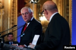 U.S. Secretary of States Rex Tillerson speaks with French Foreign Affairs Minister Jean-Yves Le Drian as they attend the Lebanon international Support Group meeting in Paris, France, Dec. 8, 2017.