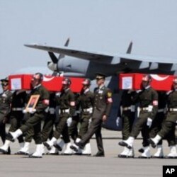 Turkish soldiers carrying the coffins of soldiers who were killed in an attack by members of the Kurdistan Workers' Party (PKK) during funerals in Van, August 18, 2011.