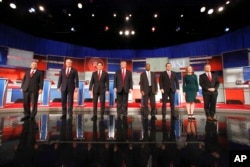 FILE - Republican presidential candidates John Kasich, Jeb Bush, Marco Rubio, Donald Trump, Ben Carson, Ted Cruz, Carly Fiorina and Rand Paul take the stage before the Republican presidential debate at the Milwaukee Theatre, Nov. 10, 2015, in Milwaukee.