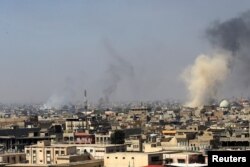 Smoke rises from the old city during a battle against Islamic State militants, in Mosul, Iraq, March 26, 2017.