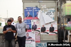 Campaign posters cover various surfaces around Baghdad, May 6, 2018. Once the national parliament is voted in, negotiations will begin to select a new head-of-state, a process that could take months.