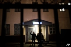 Russian opposition leader Alexei Navalny greets supporters as he leaves a police station in Moscow, Russia, Sept. 29, 2017.