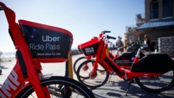 Uber's Jump electric bike share bicycles are seen along Mission Beach boardwalk Tuesday, May 28, 2019, in San Diego. (AP Photo/Gregory Bull)