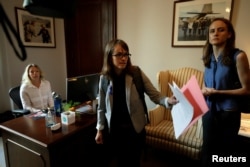 Holton-Arms alumna Alexis Goldstein (C) and Sarah Burgess arrive at office of Senator Shelley Moore Capito (R-WV) to deliver a letter from more than 1,000 fellow Holton-Arms high school graduates supporting fellow graduate Dr. Christine Blasey Ford and their belief in her accusations against Supreme Court nominee Brett Kavanaugh on Capitol Hill in Washington, Sept. 20, 2018.