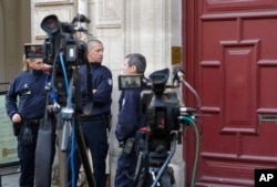 FILE - French police officers stand outside the residence of Kim Kardashian West in Paris, Oct. 3, 2016, after she was robbed at gunpoint Sunday..