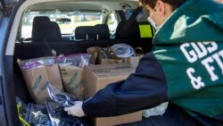 High school junior, Will Olsen, 17, of Kensington, Md., places bags holding pieces for medical face shields that were printed using personal 3D printers, into his car in Kensington, Md., Sunday, April 19, 2020. He then delivered the bags to the Eaton Hote