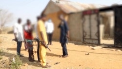 With official security forces unable to quell rising violence in Nigeria, some communities have set up informal youth patrols for protection. These men patrol a village in Kaduna state. (H. Shehu/VOA Hausa)