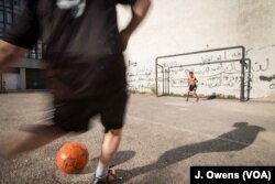 Youngsters play football on the streets of Beirut.