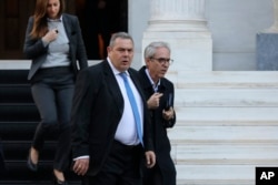 Greek Defense Minister Panos Kammenos leaves Maximos mansion following a meeting with Greece's Prime Minister Alexis Tsipras, in Athens, Jan. 13, 2019.