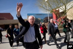 Democratic presidential candidate Sen. Bernie Sanders of Vermont waves to voters as he leaves a caucus site in Las Vegas, Feb. 20, 2016.
