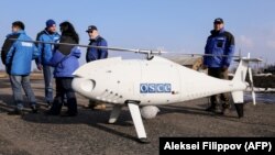 UKRAINE -- Members of the Organization for OSCE Observer Mission, Special Monitoring Mission in Ukraine, arrive for the test flight of the unmanned aerial vehicle Camcopter S-100 along the eastern front line near the village of Stepanivka in the Donetsk, March 28, 2018.