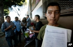 FILE - Illegal immigrant Layios Roberto waits outside the offices of Coalition for Humane Immigrant Rights in Los Angeles, Aug. 15, 2012.