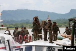 FILE - Myanmar soldiers arrive to Buthidaung jetty after Arakan Rohingya Salvation Army's (ARSA) attacks, at Buthidaung, Myanmar, Aug. 29, 2017.