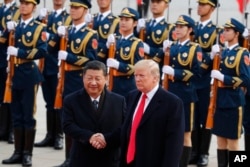 U.S. President Donald Trump, right, shakes hands with Chinese President Xi Jinping during a welcome ceremony at the Great Hall of the People in Beijing, Nov. 9, 2017.