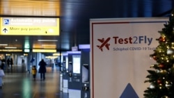 A sign points the way for a Covid-19 test center at the Schiphol airport, Netherlands, Nov. 29, 2021.