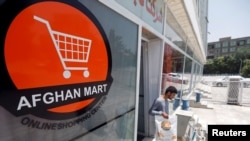 A customer leaves from an online shop in Kabul, Afghanistan, June 4, 2018.