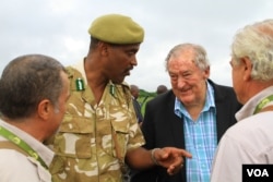 Kenya Wildlife Service director Kitili Mbathi and Kenya Wildlife Service Chairman Richard Leakey speak with attendees at Kenya’s ivory burn in Nairobi National Park, April 30, 2016. (J. Craig/VOA)
