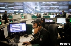 Saudi security guards monitor screens at the National Center for Security Operations in the holy city of Mecca, Saudi Arabia, Aug. 29, 2017.