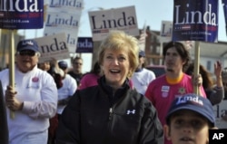 FILE - Republican candidate for U.S. Senate Linda McMahon, center, marches in the Spirit of Waterbury parade in Waterbury, Conn., Oct. 23, 2010.