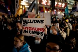 FILE - Demonstrators supporting Tibetans, Uyghurs and Hong Kongers take part in a protest against the Chinese Communist Party as they march along Regent Street People's Republic of China, as they march along Regent Street towards the Chinese Embassy, in London, Oct. 1, 2021.