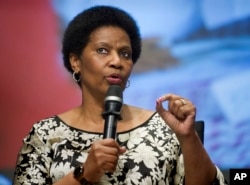FILE - Phumzile Mlambo-Ngcuka, executive director, UN Women, addresses the World Bank Group's report on pervasive constraints facing women and girls worldwide, World Bank headquarters, Washington, May 14, 2014.