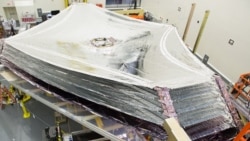 The sun shield of the James Webb Space Telescope separates the observatory into a warm, sun-facing side and a cold side. The five-layer sunshield keeps sunlight from interfering with the sensitive telescope instruments. (Photo Credit: Northrop Grumman)