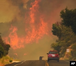 This July 8, 2017, photo released by the Santa Barbara County Fire Department shows a Santa Barbara City Fire vehicle on Highway 154 in the Whittier fire east of Cachuma Lake in Santa Barbara County, California.
