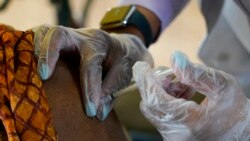 FILE - In this Jan. 12, 2021, photo, a resident of Harmony Court Assisted Living receives the Pfizer COVID-19 vaccine in Jackson, Miss.