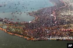 FILE - An Ariel view of thousands of Hindu devotees taking dips at Sangam, the confluence of three sacred rivers the Yamuna, the Ganges and the mythical Saraswati, on Mauni Amavsya or the new moon day.