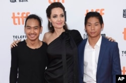 Maddox Jolie-Pitt, from left, Angelina Jolie and Pax Jolie-Pitt attend a premiere for "First They Killed My Father" at the Toronto International Film Festival at the Princess of Wales Theatre, Sept. 11, 2017, in Toronto.