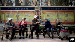 FILE - A group of elderly women rest in their wheelchairs at a residential compound in Beijing, China, March 31, 2016. By 2030, the number of elderly people in Asia is forecast to increase by 200 million.
