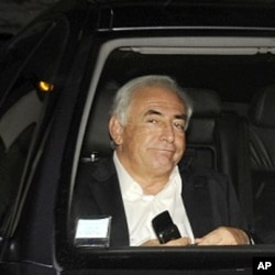 Former IMF chief Dominique Strauss-Kahn leaves his apartment, hours after being questioned by police, in Paris September 12, 2011.