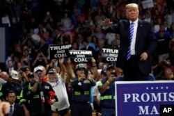 FILE - President Donald Trump waves after speaking during a rally, Aug. 21, 2018, in Charleston, W. Va.