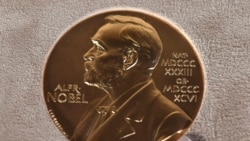 FILE - A Tuesday, Dec. 8, 2020 file photo of a Nobel medal displayed during a ceremony in New York.