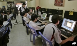 FILE - Students surf web at an Internet cafe in Hanoi, Vietnam, March 31, 2010.