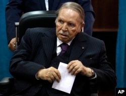 FILE - Algerian President Abdelaziz Bouteflika prepares to vote in Algiers, May 4, 2017.
