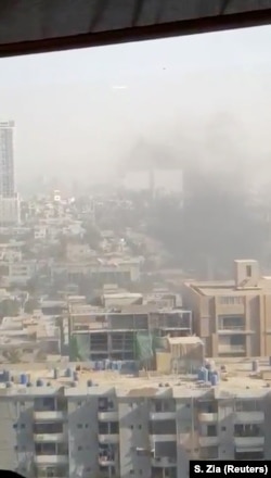 Smoke rises from the Chinese consulate after an attack by gunmen in Karachi, Pakistan, Nov. 23, 2018, in this still image taken from a video obtained from social media.