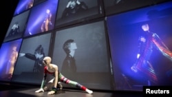 A striped asymmetric catsuit by Yansai Yamamoto (1973), used by performer David Bowie, is seen at the "David Bowie is" Exhibition in London, March 20, 2013.