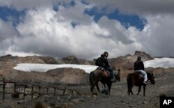 A group of tourists ride horses to the Pastoruri glacier in a tour called "The Route of Climate Change" in Huaraz, Peru, Aug. 12, 2016.