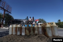 Containers filled with fuel that is sold on the black market are offered in a street in Port-au-Prince, Haiti, February 24, 2019.