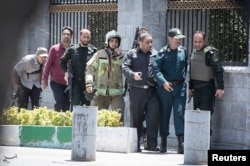 Members of Iranian forces are seen during an attack on the Iranian parliament in central Tehran, Iran, June 7, 2017.