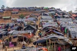 Newly set up tents cover a hillock at a refugee camp for Rohingya Muslims, who crossed over from Myanmar into Bangladesh, in Taiy Khali, Bangladesh, Friday, Sept. 22, 2017.