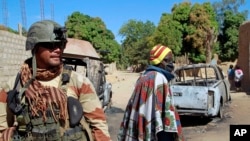 FILE - A French soldier secures a perimeter on the outskirts of Diabaly, Mali, Jan. 21, 2013.
