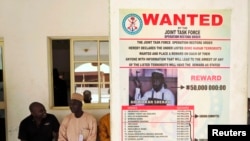 A poster advertising for the search of Boko Haram leader Abubakar Shekau is pasted on a wall in Baga village on the outskirts of Maiduguri, May 13, 2013.
