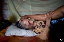 Maria Victoria, 89, is comforted by her daughter Mariana in Estancia Las Palmas, Ecuador, April 19, 2016. Maria Victoria was injured when a column fell on her after 7.8-magnitude earthquake collapsed her home.