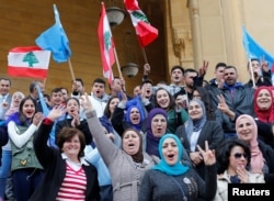 Supporters of Saad al-Hariri, who suspended his decision to resign as prime minister, hold flags and chant slogans near Martyrs' Square in downtown Beirut, Lebanon, Nov. 22, 2017.