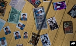 The wet personal belonging of a migrant man are spread out to dry in the sun after he was rescued from the Mediterranean sea, about 13 miles north of Sabratha, Libya, Monday, Aug. 29, 2016.