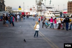 While some are keen to take the buses to other camps, others remain skeptical that their lives will improve, Athens, Greece, April 15, 2016. (Photo: J. Owens/VOA)